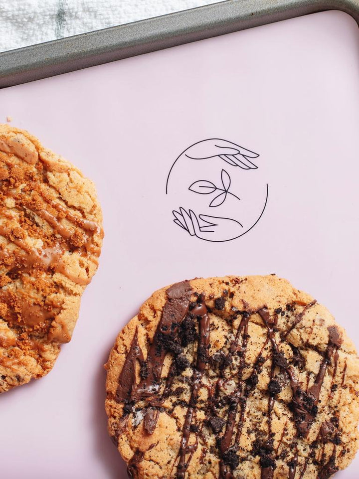 Chocolate Chip and Almond Butter Cookies on a pink baking mat showing the Sasstainable logo