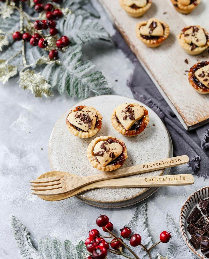 chocolate chip mince pies on a plate with bamboo cutlery