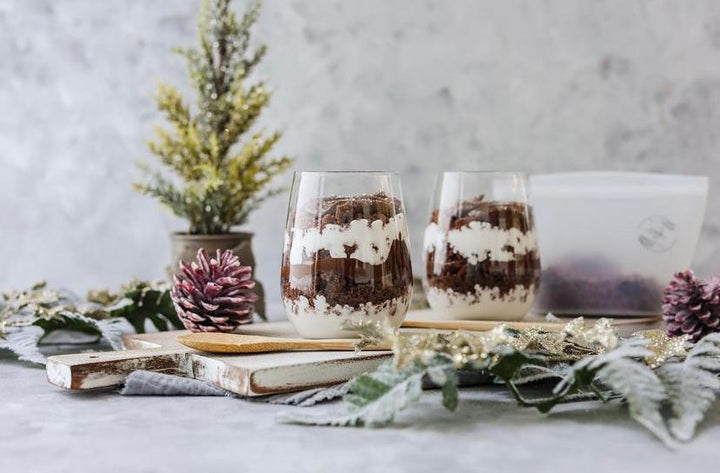 Two glasses containing a dessert with a pine cone and silicone pouch