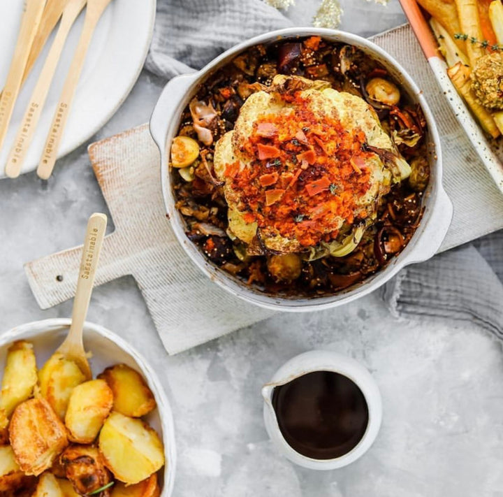 Roasted Cauliflower centrepiece surrounded by roast vegetables