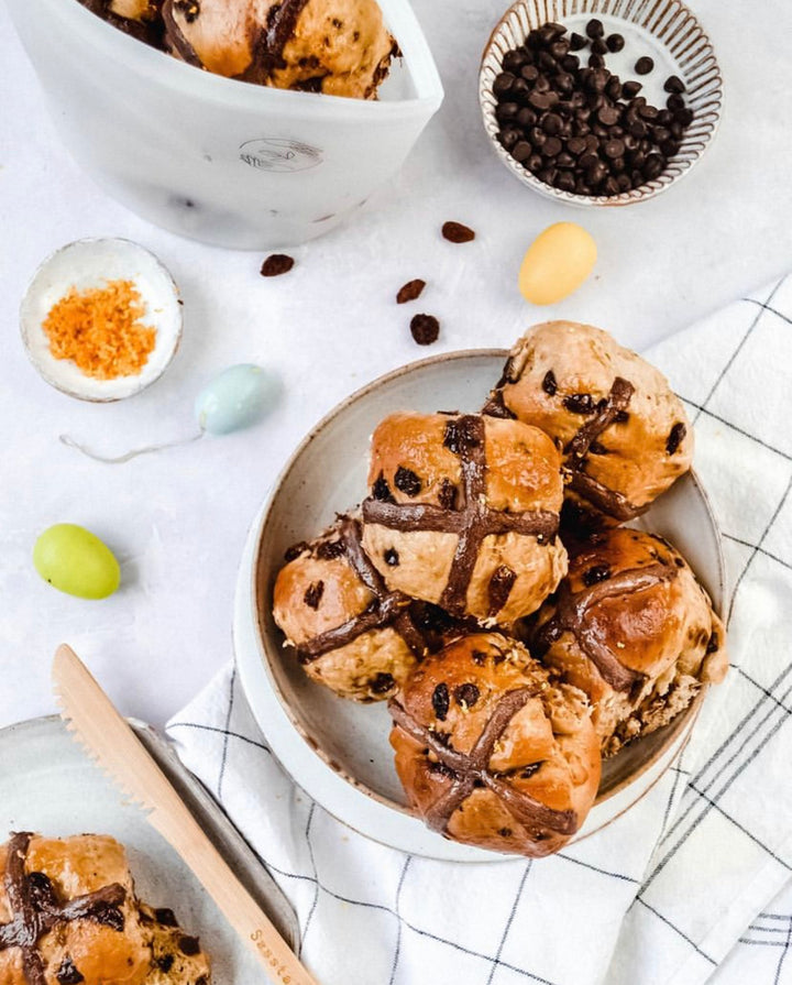 Chocolate hot cross buns in a bowl