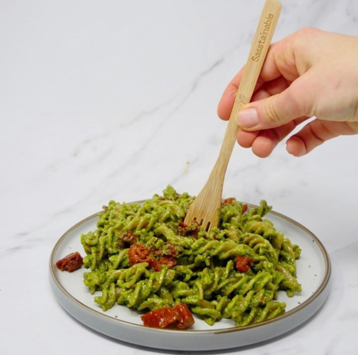 Green pesto pasta served on a plate