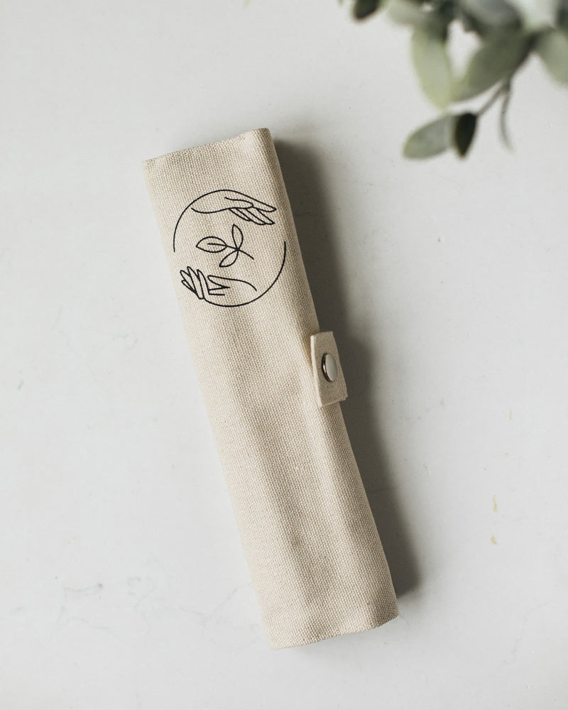 Rolled up beige canvas case featuring Sasstainable logo