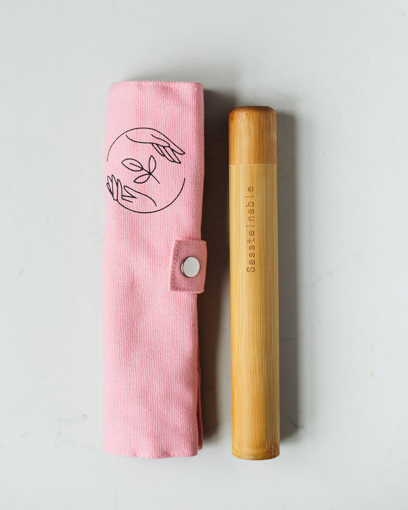 Rolled up pink canvas case with bamboo tube, featuring Sasstainable logo
