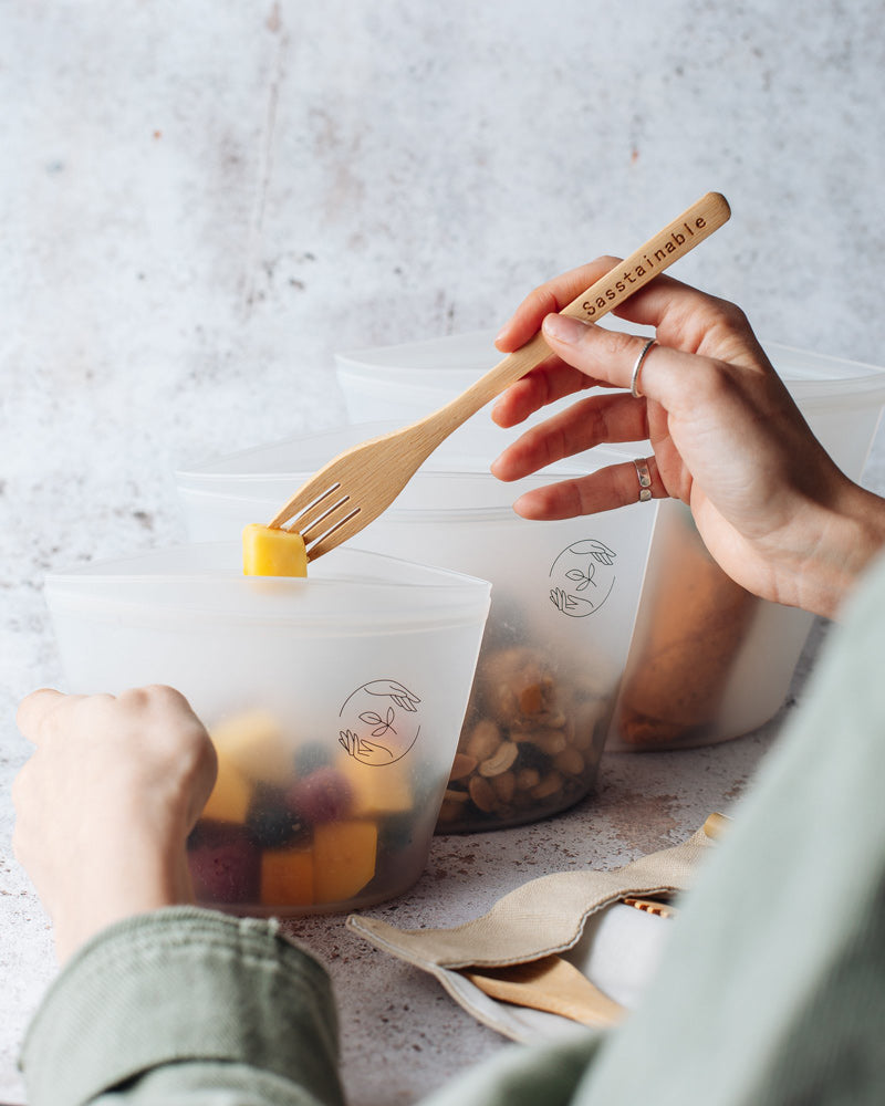 Eating fruit with a bamboo fork from the small reusable silicone pouch