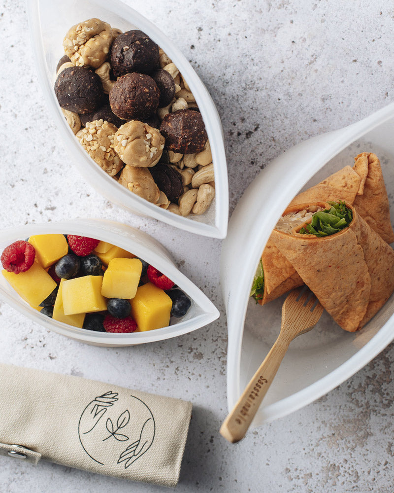 Aerial view of picnic food in the three reusable pouch sizes with bamboo cutlery